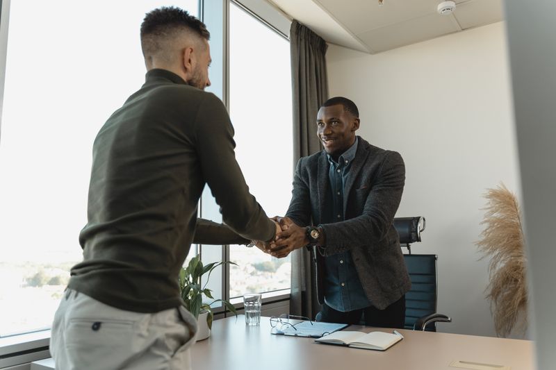 Two business professionals shaking hands after agreeing on a partnership